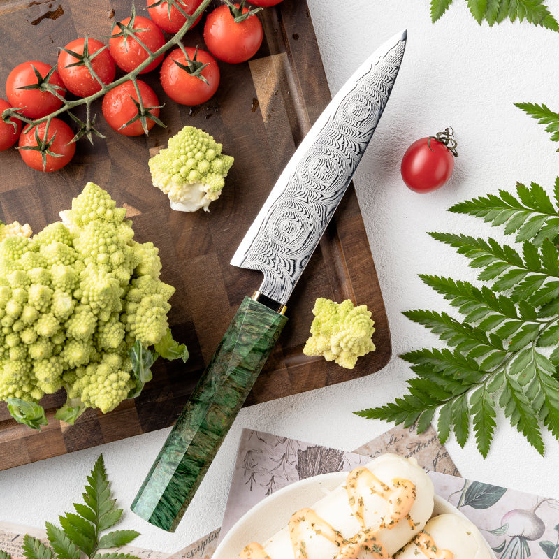 Decorative Rose Damascus Pattern knife on a cutting board with vegetables and tomatoes