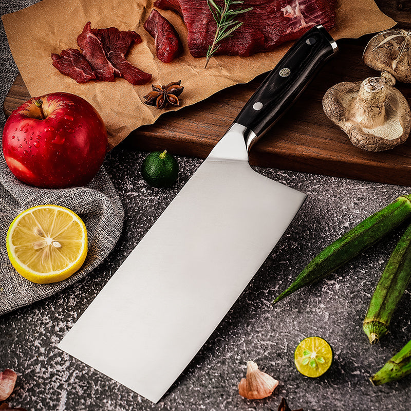 Professional and sharp cleaver knife for meat with ingredients like apples, lemons, and okra.