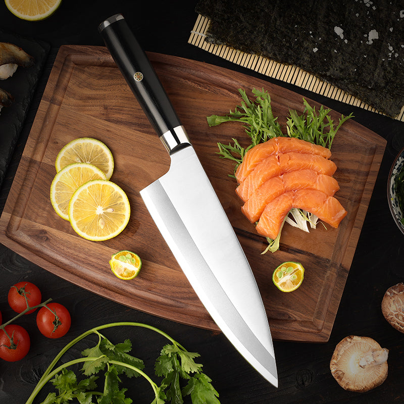 Wooden cutting board with sliced salmon, lemon, and a Hikari fish knife branded Hikari Knife on a dark surface.