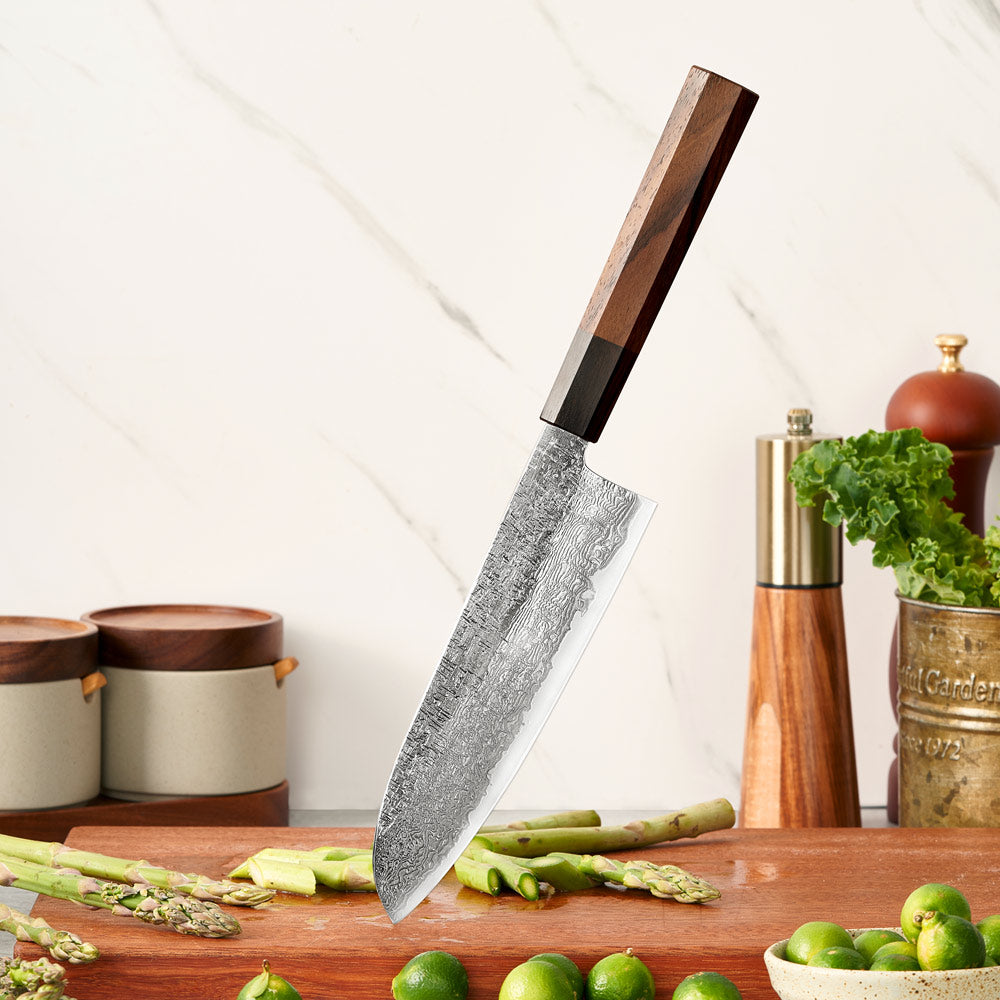 Chef's knife with a wooden handle on a kitchen counter with vegetables and containers.
