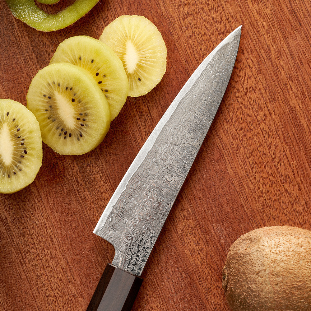 Decorative chef's knife on a wooden surface with sliced kiwis