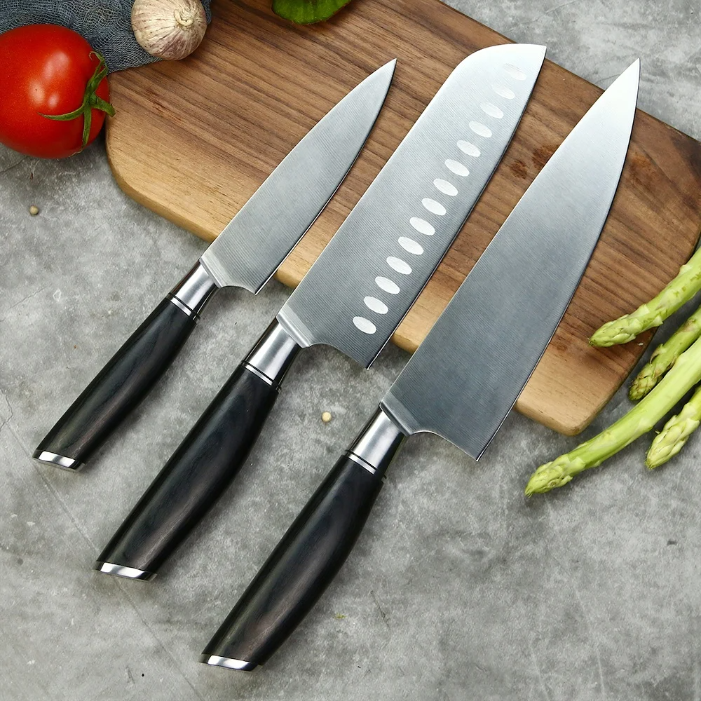 Set of 3 German Steel knives on a wooden cutting board: Chef, Santoku and utility