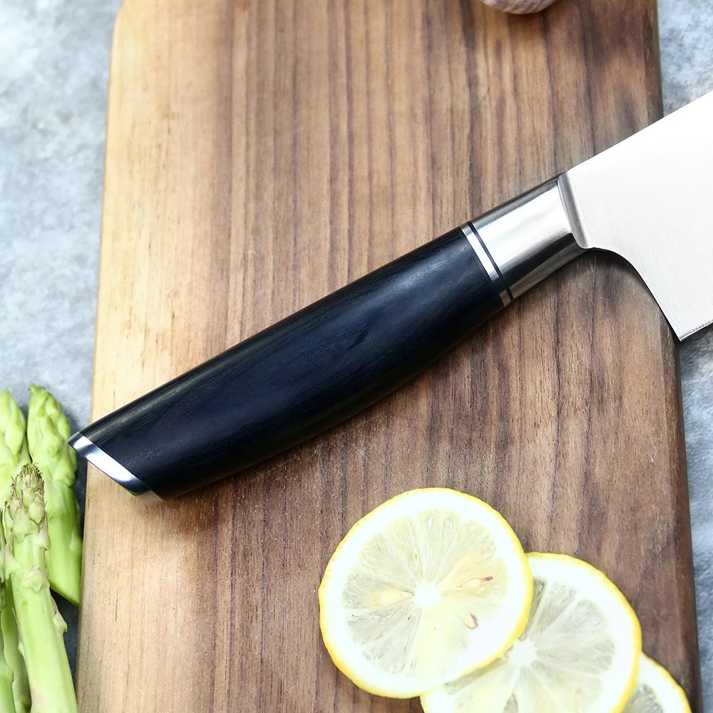 Chef Knife german steel with black pakkawood handle on a wooden cutting board