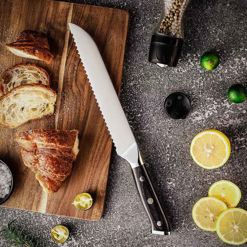 Bread Knife german steel blade full tang on a wooden cutting board with sliced bread and lemons on a dark surface