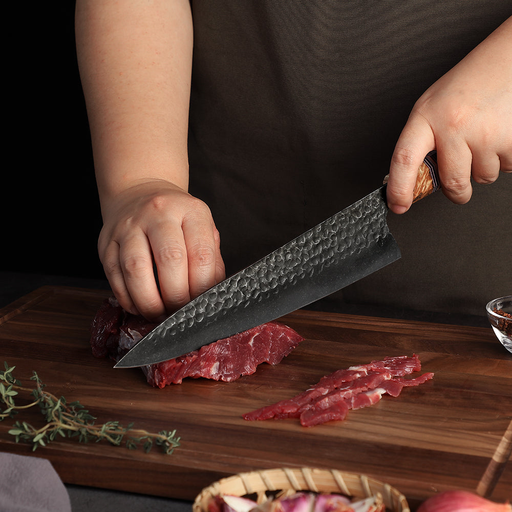 CHef cutting steak with kitchen knife