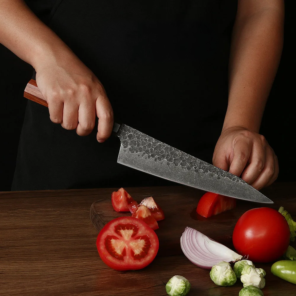 professional chefs easily cuts tomatoes with japanese knife