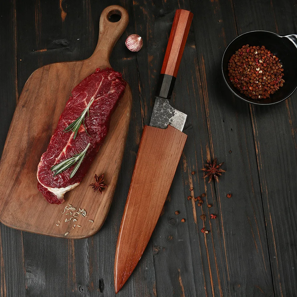 japanese professional knife on wooden table cutting steak