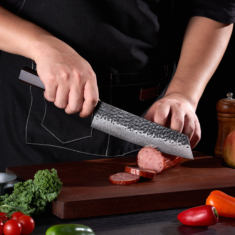 Professional chef cuts meat with damascus knife