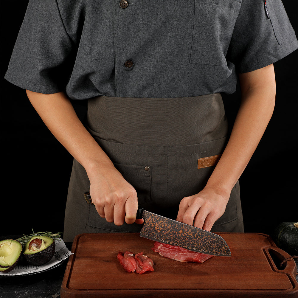 japanese chef cutting steak with damascus knife