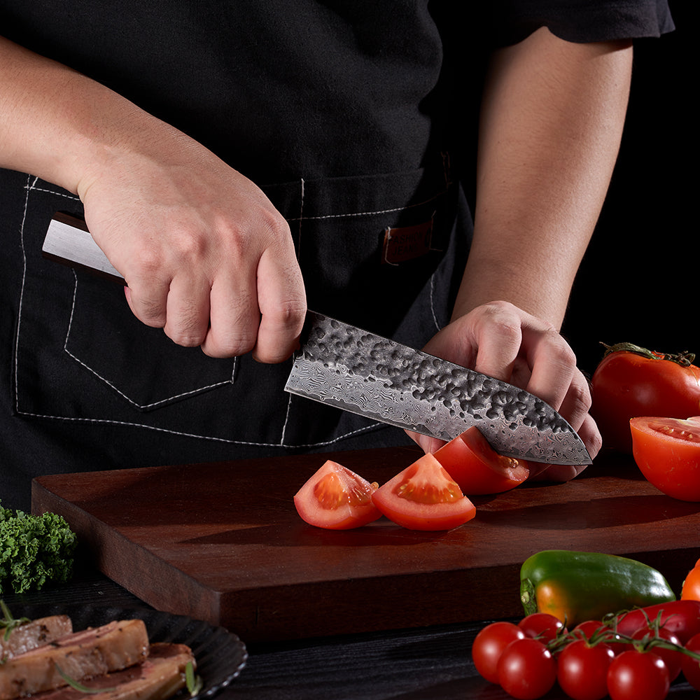 Sharp japanese kitchen knife easily slicing tomatoes