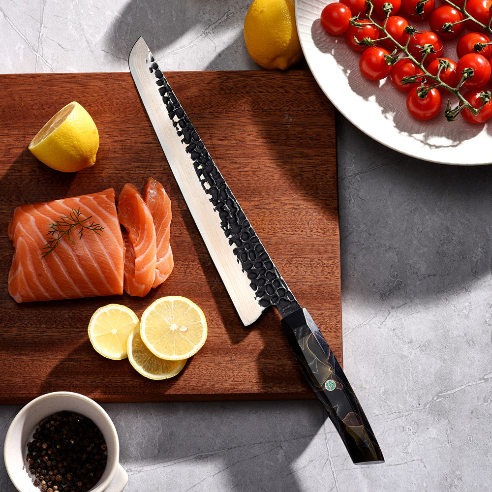 Wooden cutting board with salmon, lemons, and a slicer / slaugther knife on a gray surface.